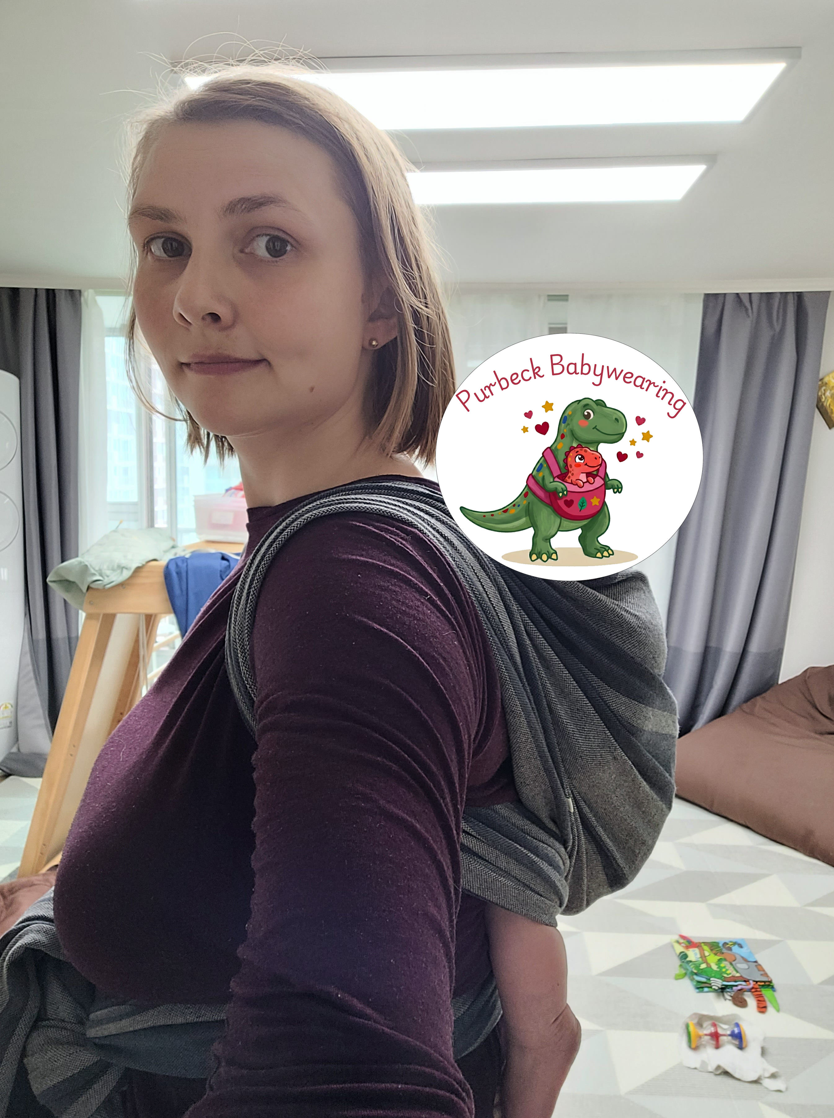 Caregiver babywearing by the coast